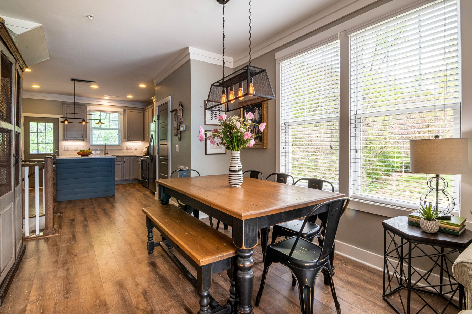 Bright dining room with a solid wood table, bench and chairs