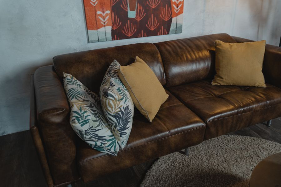 Brown leather sofa with cushions